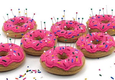 Multiple fabric pink frosted donut pincushions